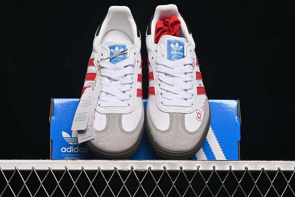 Front view of the pair showing white laces, gray toe overlays, and red details