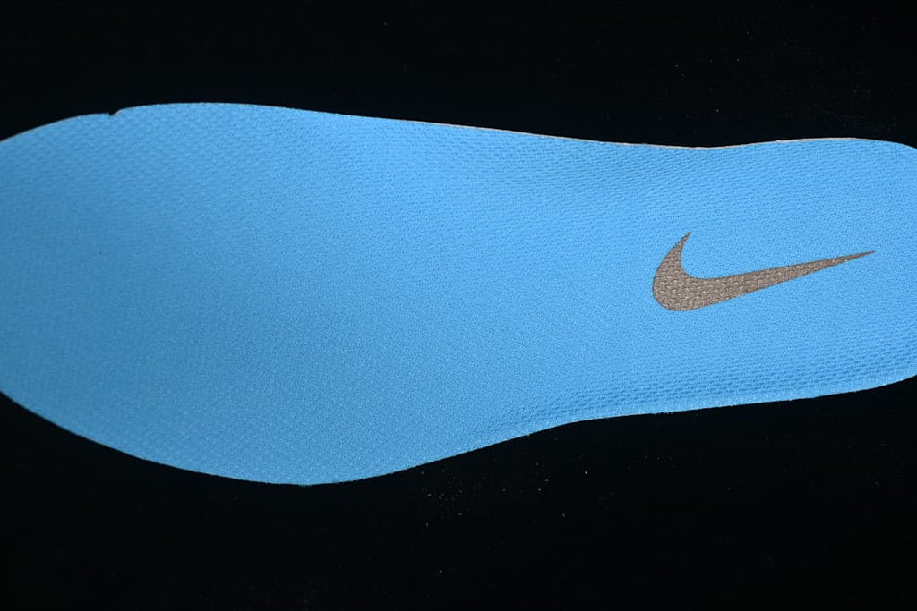 Close-up of the blue shoe insert with a Swoosh logo.