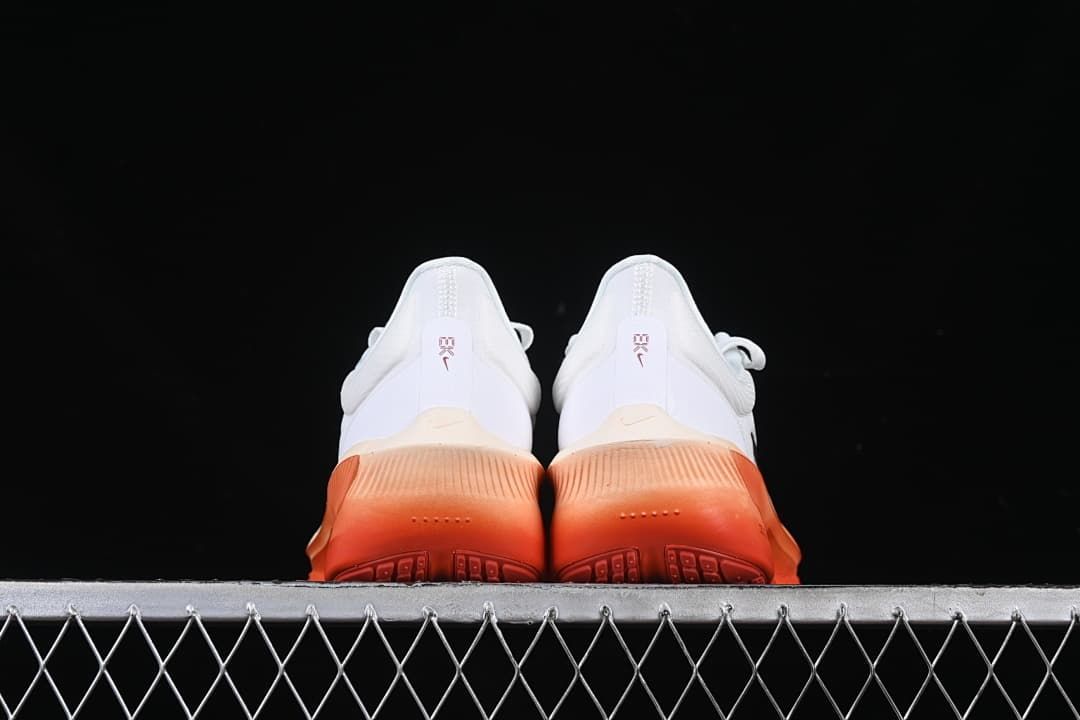 Rear view of the pair showing coral-orange heel soles