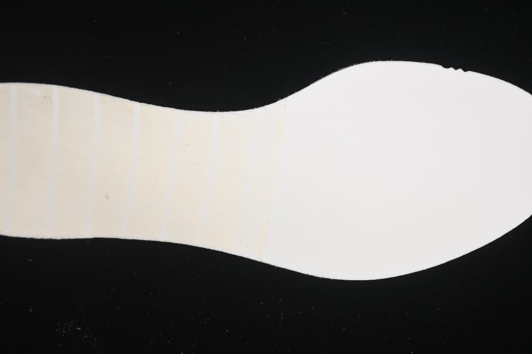 Underside of the shoe showing a light-colored outsole
