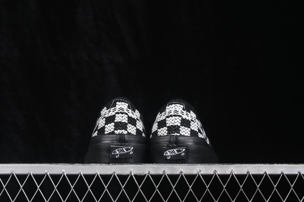 Rear view of the pair showing the checkerboard heel panels, black heel sections and Vans heel labels.