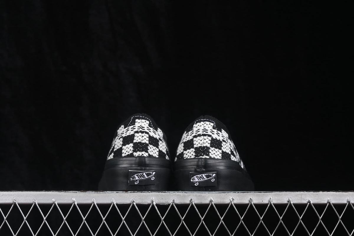 Rear view of the pair showing the checkerboard heel panels, black heel sections and Vans heel labels.