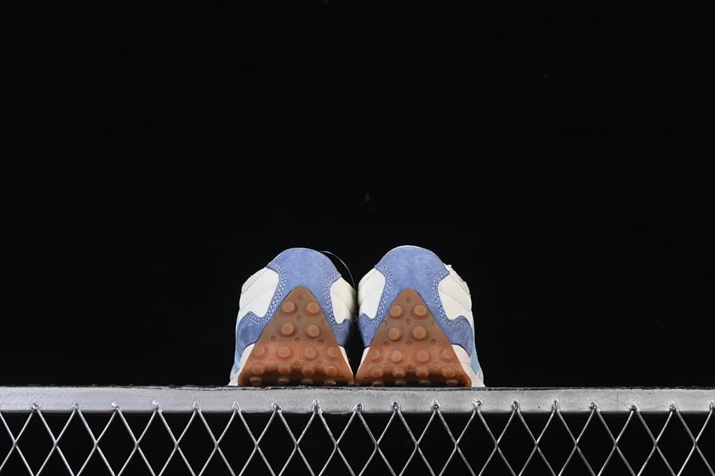 Rear view of the pair showing the blue heel panels and gum-colored outsoles.
