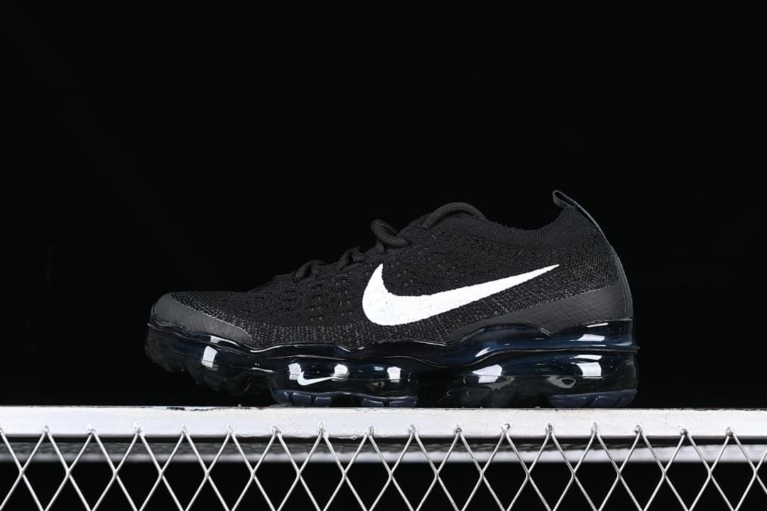 Side view of a black Nike Air VaporMax sneaker with a white Swoosh and visible air-cushioned sole.