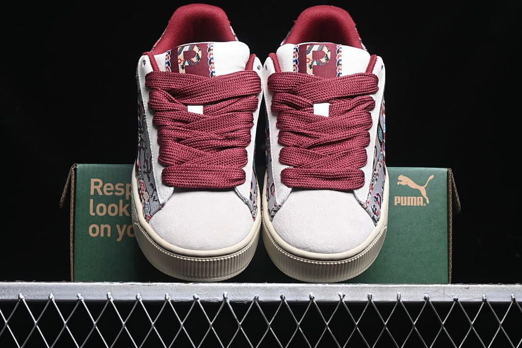 Front view of the pair showing burgundy laces and patterned tongue details