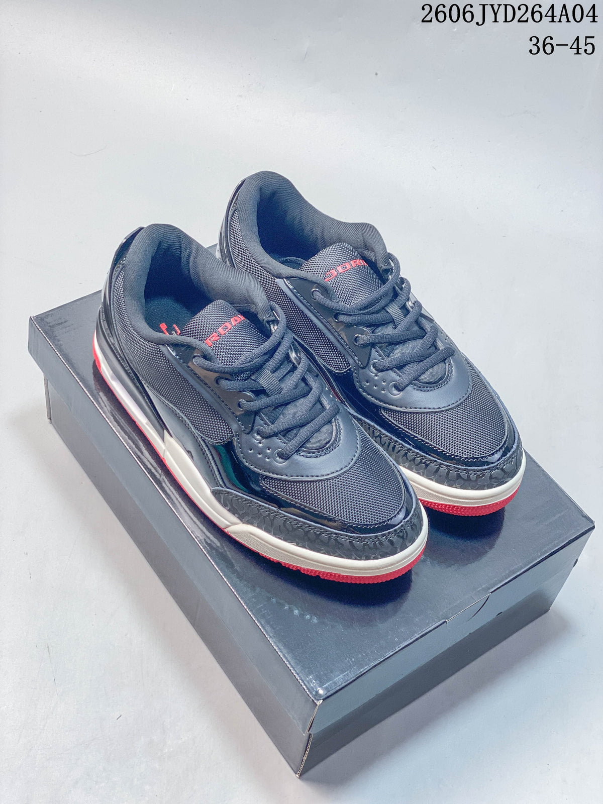 Pair of dark navy and charcoal Jordan Air Jordan Ultra sneakers with red outsole accents, photographed on a shoebox