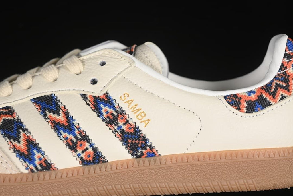 Close-up of the patterned side stripes, cream upper, and gum outsole