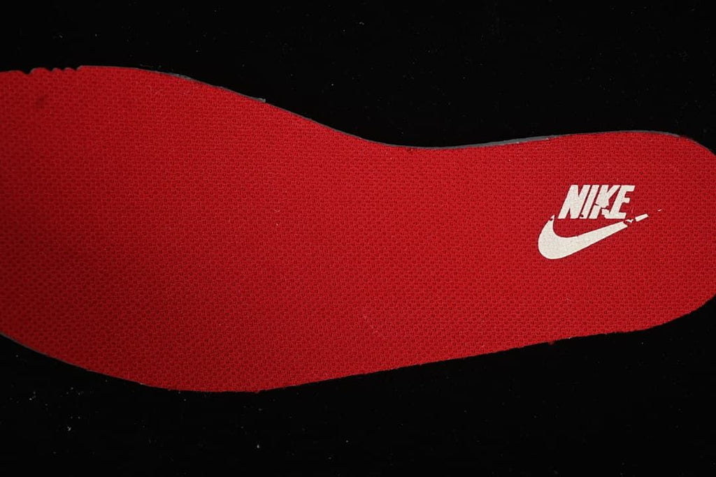 Red insole with a white Nike logo.
