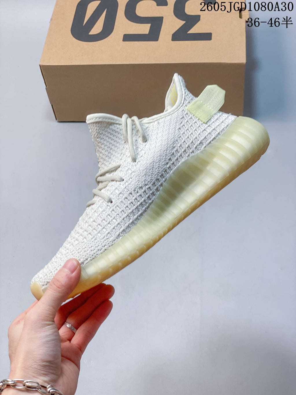 Side view of a light knit sneaker with a heel pull tab