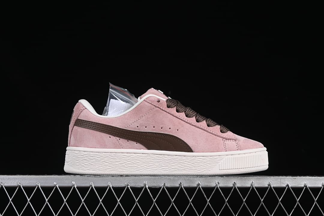 Side profile of a pink sneaker with a brown Formstrip and white sole.