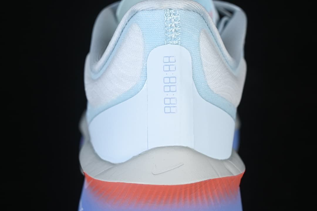 Rear view of Nike Zoom Fly 6 showing heel details and coral and violet sole.