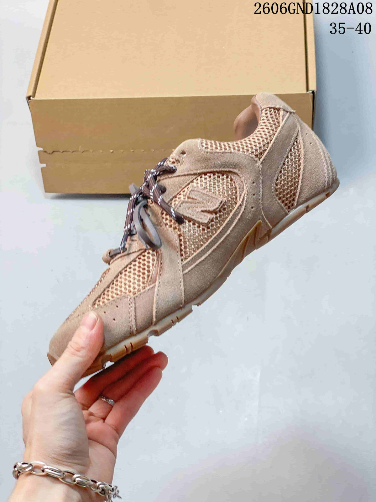 Side view of a rose-beige mesh sneaker with suede-look overlays.