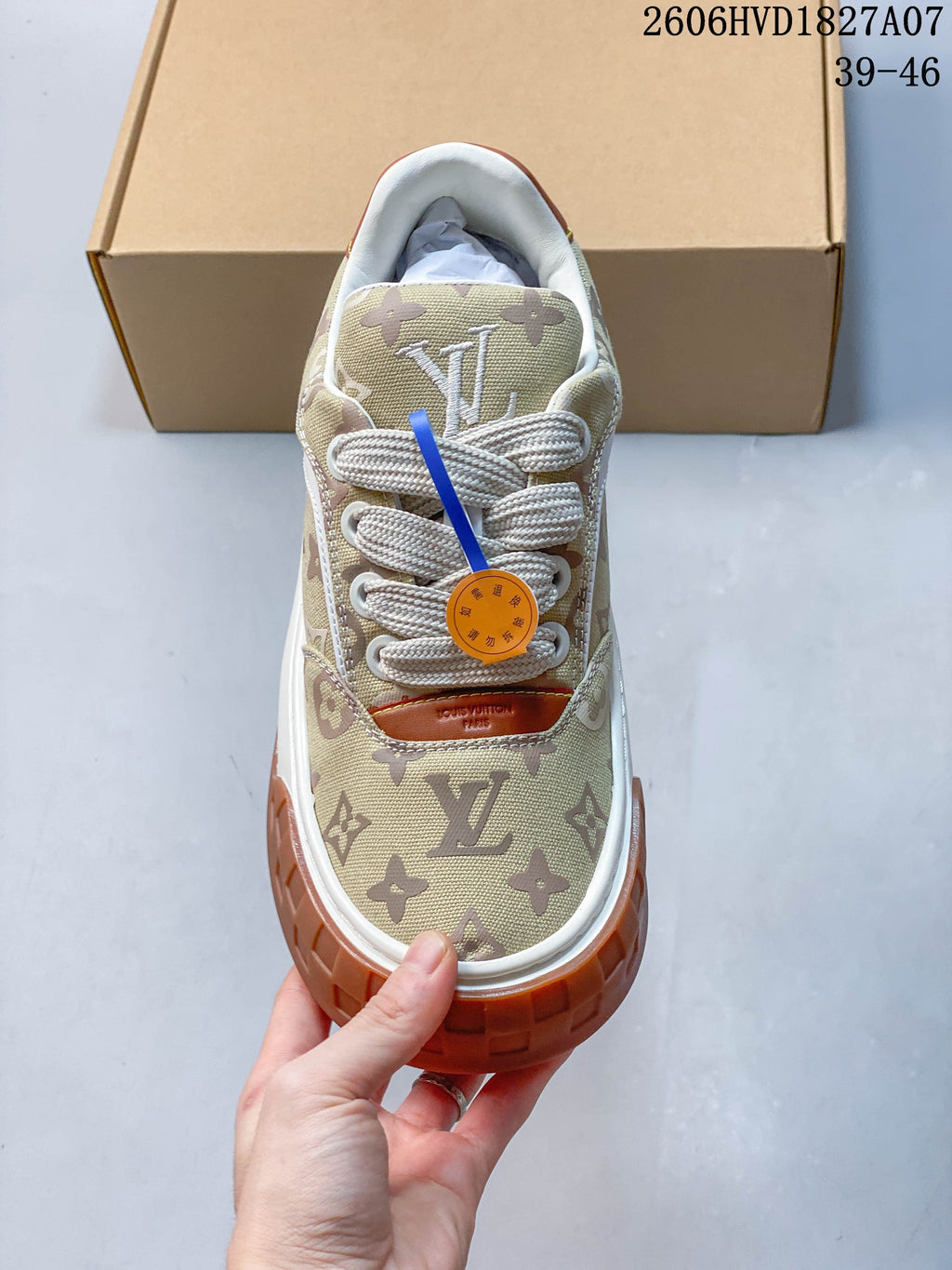 Top view of the sneaker showing its monogram-patterned toe and cream laces.