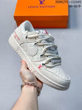 White low-top sneaker held in front of an orange Louis Vuitton-marked shoe box, showing gray patterned laces, perforated toe panels, and side detailing.