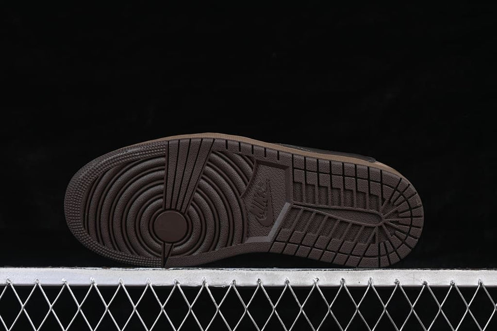 Underside view of the brown outsole and circular tread pattern