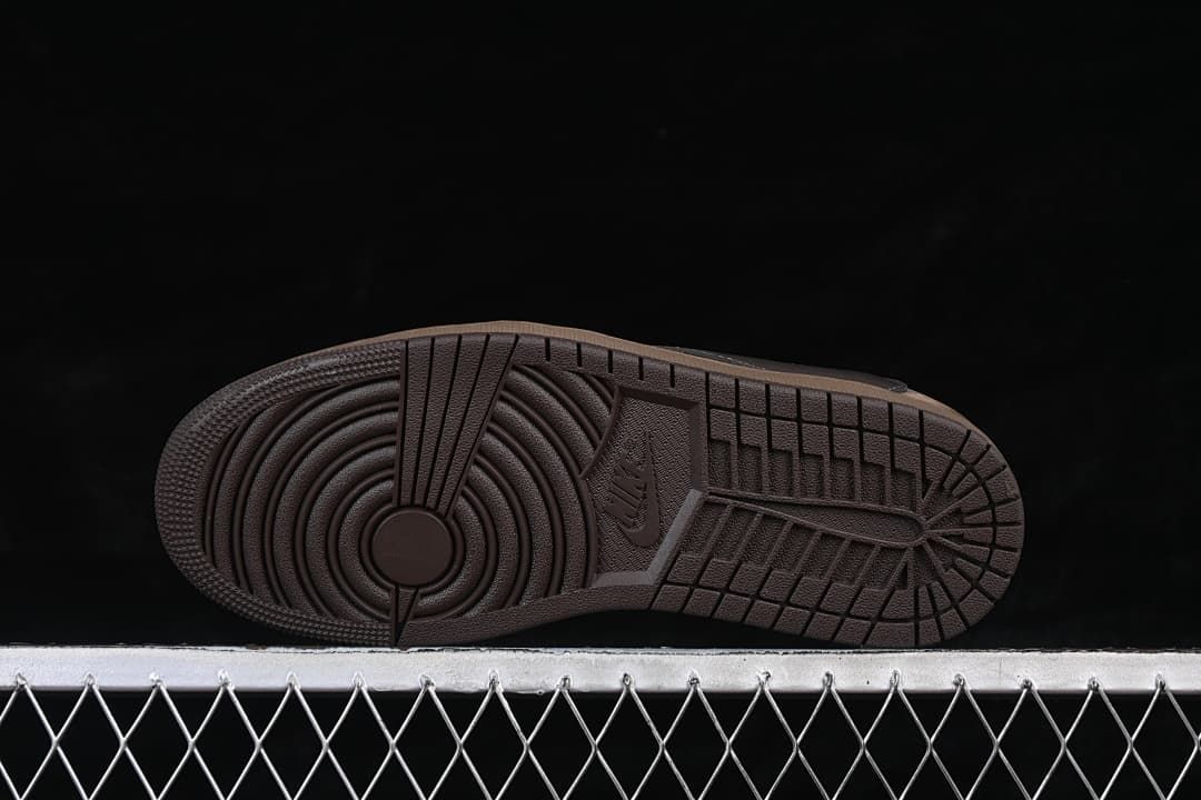 Underside view of the brown outsole and circular tread pattern