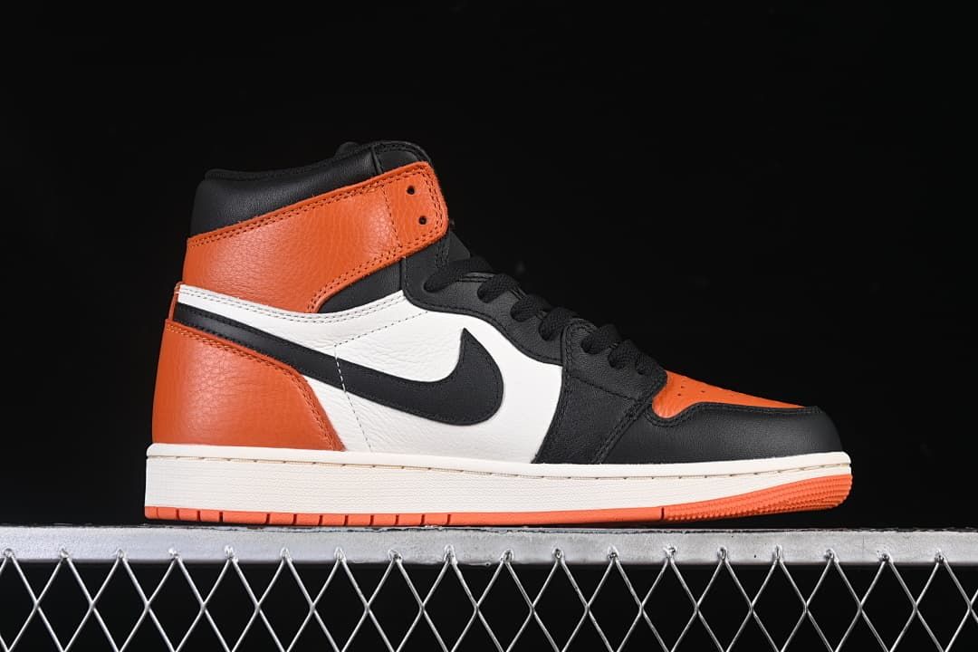 Side profile of the high-top sneaker in orange, black and white