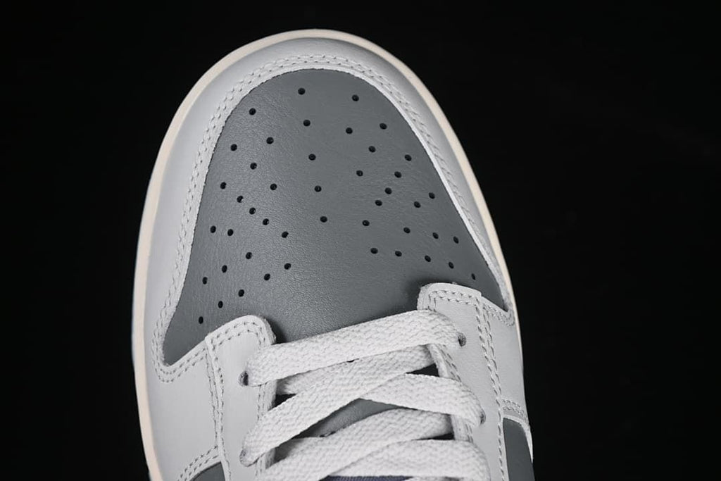 Top view of perforated grey toe and white laces
