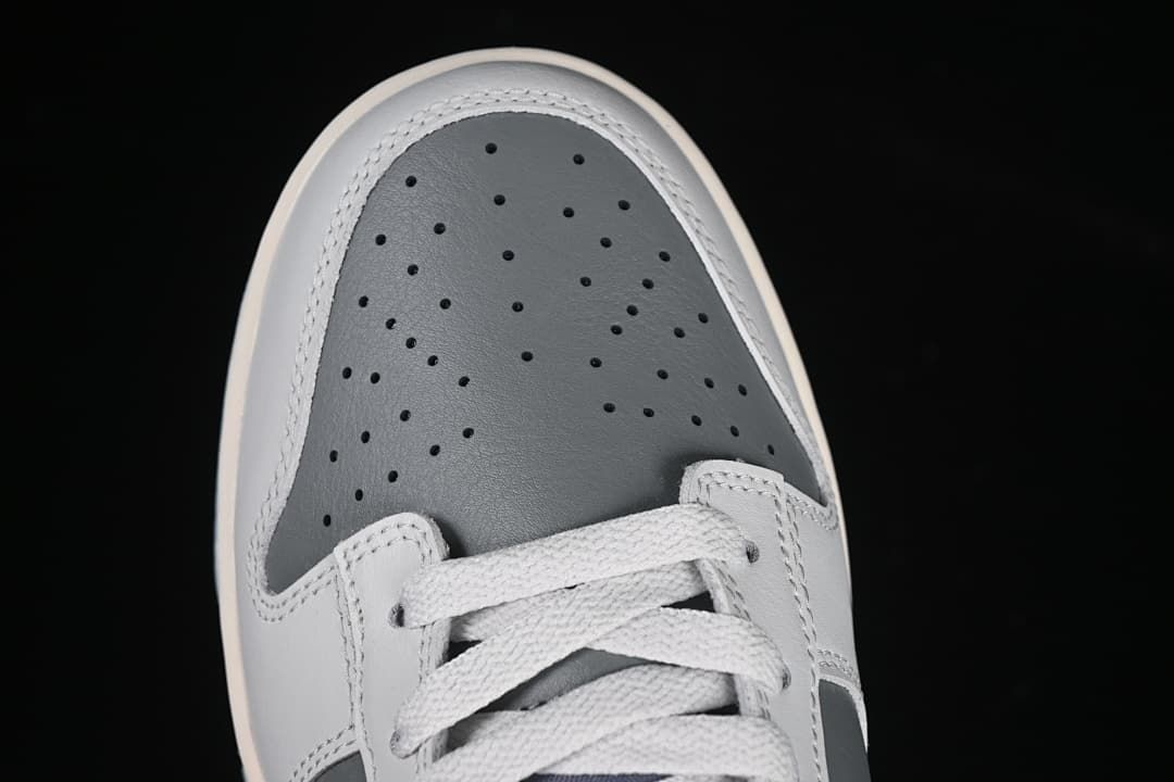 Top view of perforated grey toe and white laces