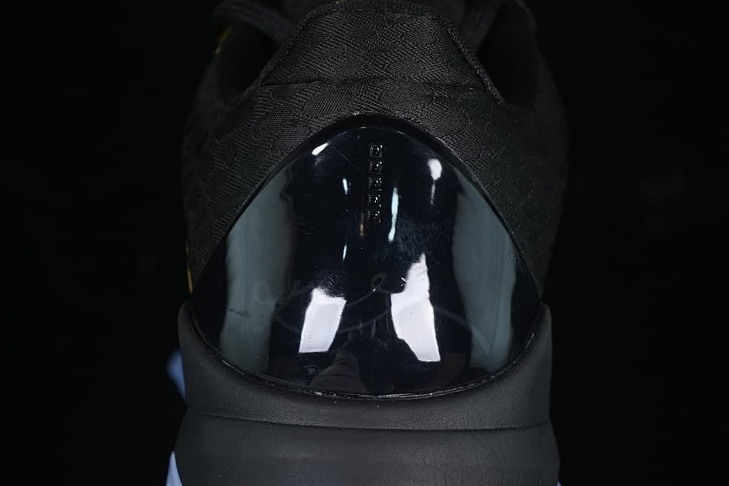 Rear close-up of the shoe with a glossy black heel panel