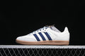 Side view of a white adidas Samba OG sneaker with navy stripes, patterned laces, and a gum-colored sole.