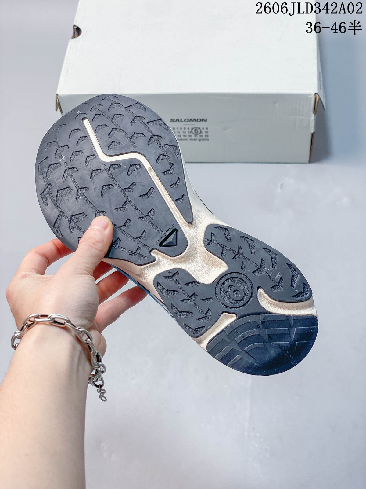 Close-up of the lugged outsole on a Salomon trail shoe