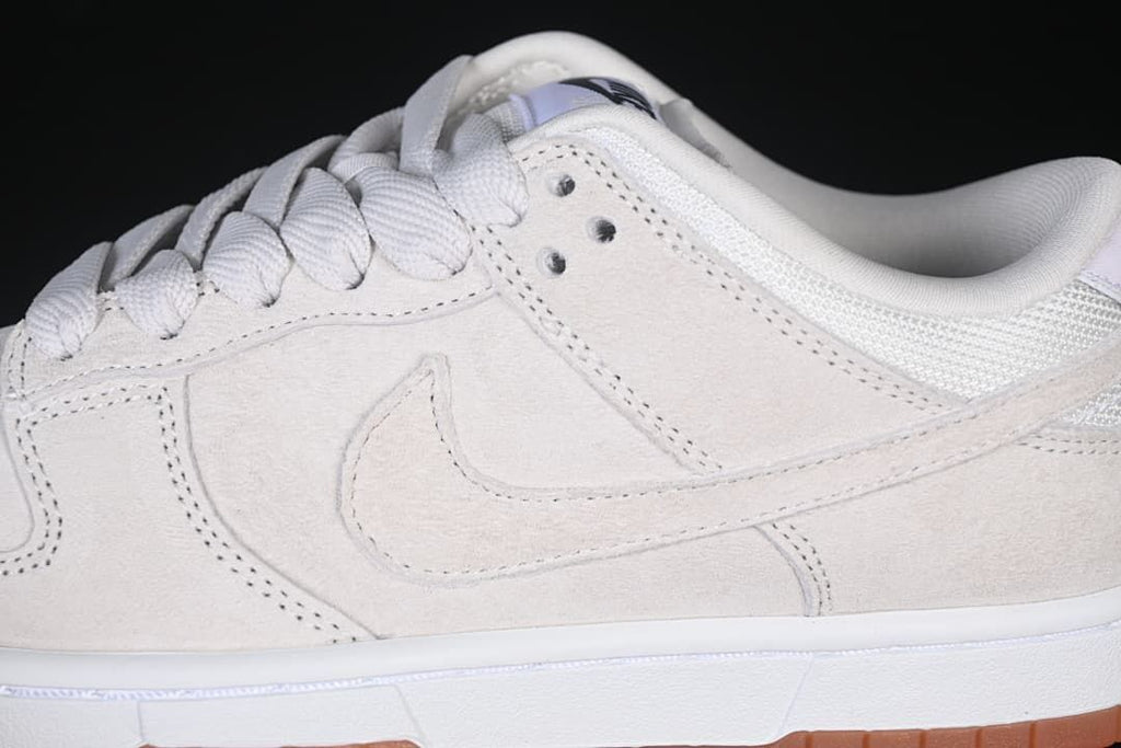 Close-up of the side Swoosh, lace eyelets, and upper