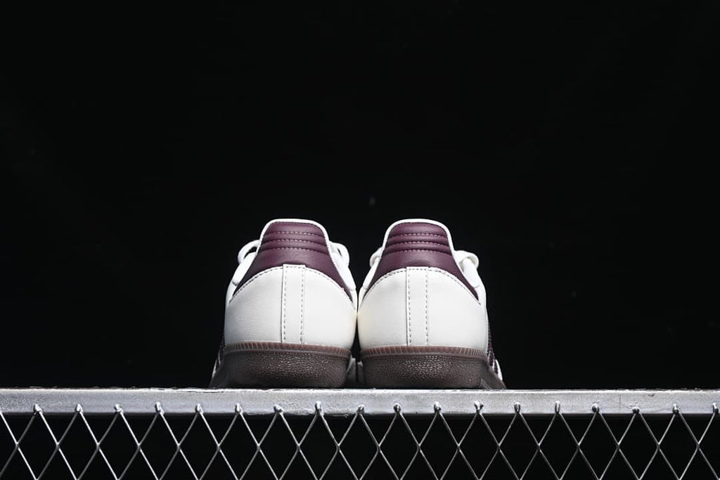 Rear view of both sneakers showing burgundy heel tabs