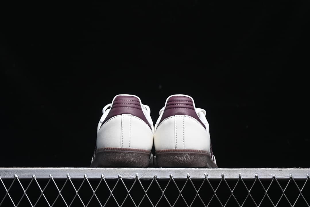 Rear view of both sneakers showing burgundy heel tabs