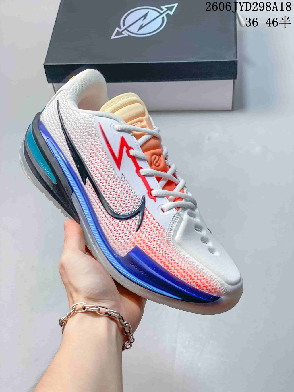 White Nike Air Zoom GT Cut low-top shoe with red, black, blue, and orange accents.