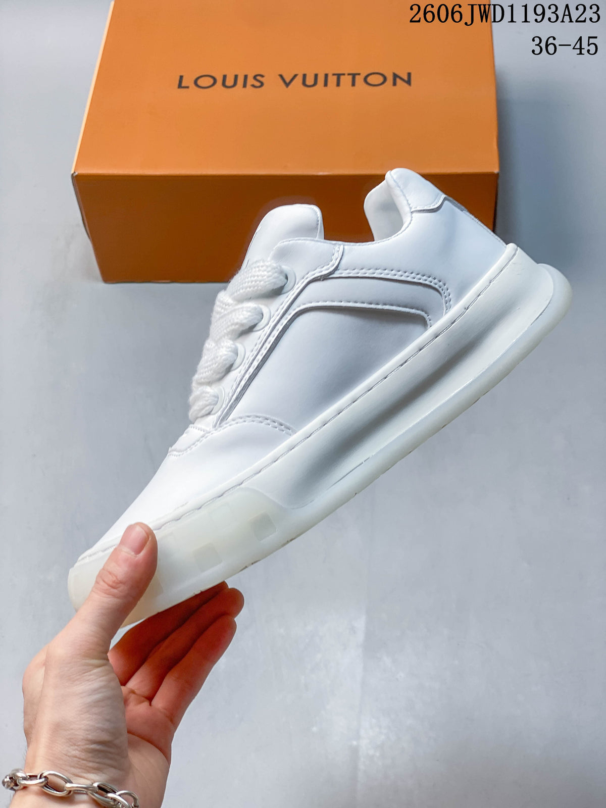 Side profile of a white low-top lace-up sneaker with thick sole