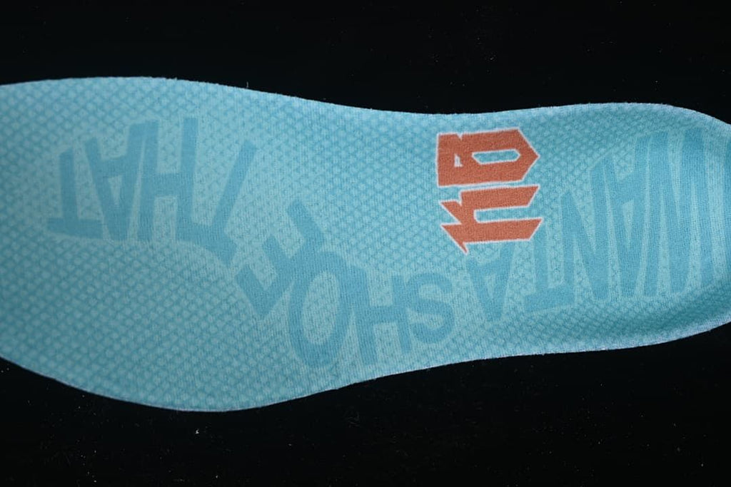 Close-up of the turquoise insole with Kobe branding.