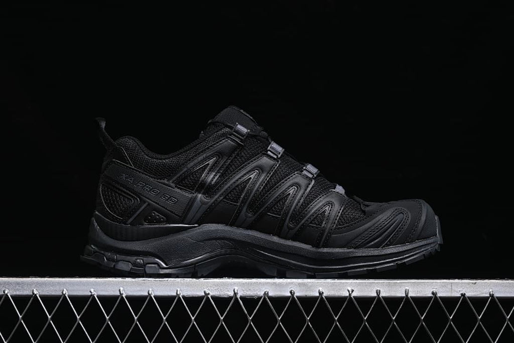 Side profile of the black XA Pro 3D shoe with its lacing and outsole visible