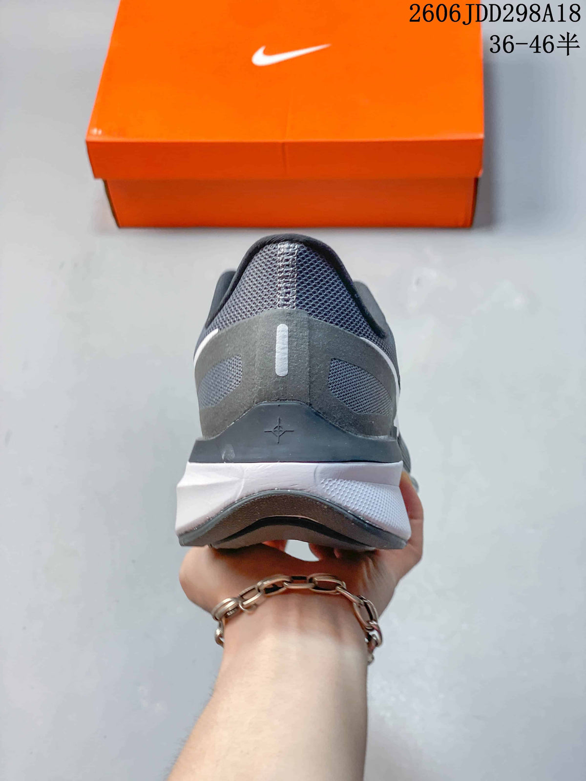 Rear view of a gray Nike running shoe showing the heel and midsole
