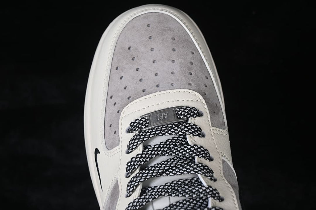 Top-down close-up of the perforated grey toe panel and patterned laces.