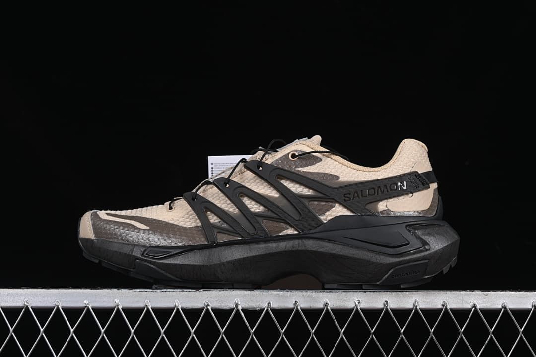Side profile of a beige and black Salomon XT Pu.re Advanced shoe