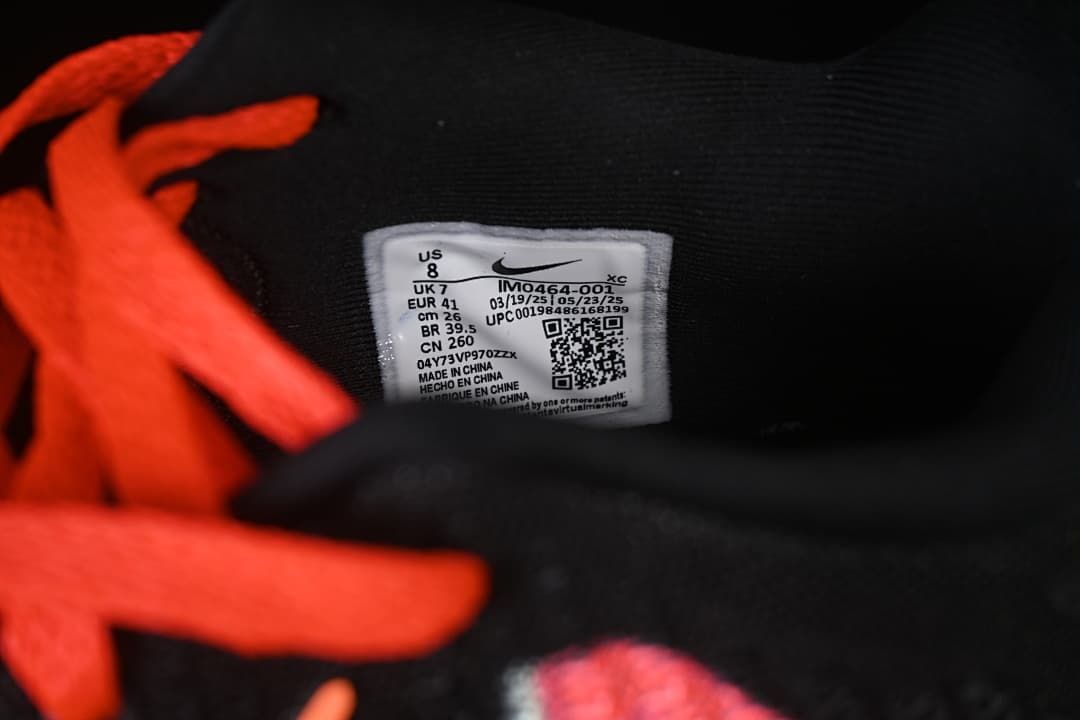 Orange-red laces beside the shoe's interior size label.