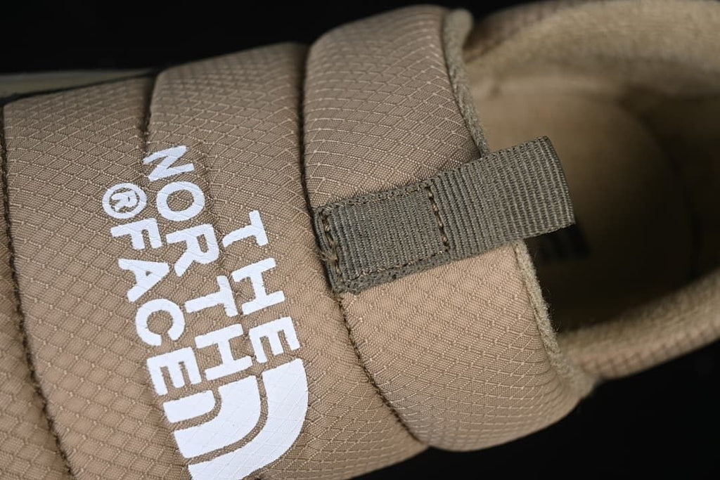Close-up of the branded instep strap and pull tab
