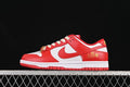 Side view of a red and white Nike Dunk Low with patterned laces and gold-tone accents