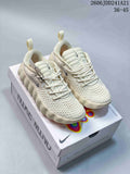 Pair of cream Nike Mind sneakers on a Nike Mind box