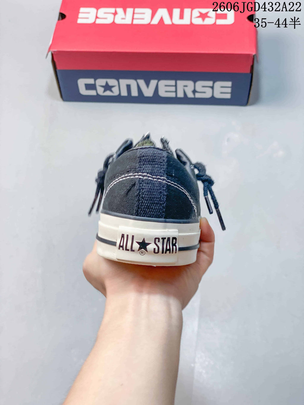 Rear view of a black Converse sneaker with All Star heel branding.
