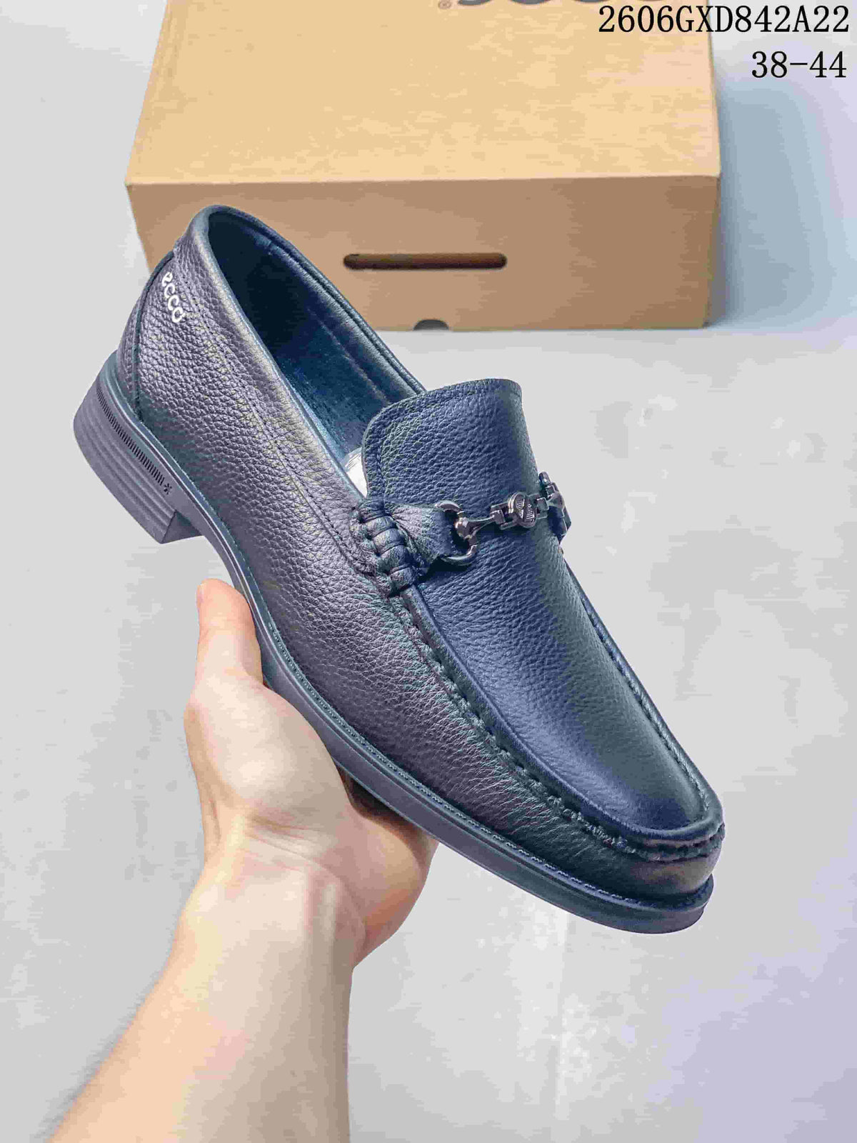 Close-up side view of a black leather-style loafer with metal bit detail.