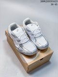 White and silver ASICS Gel-Pickax sneakers shown on a shoe box.