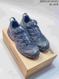 Dark gray Salomon XA Pro 3D sneakers shown on a shoe box from above at an angle.