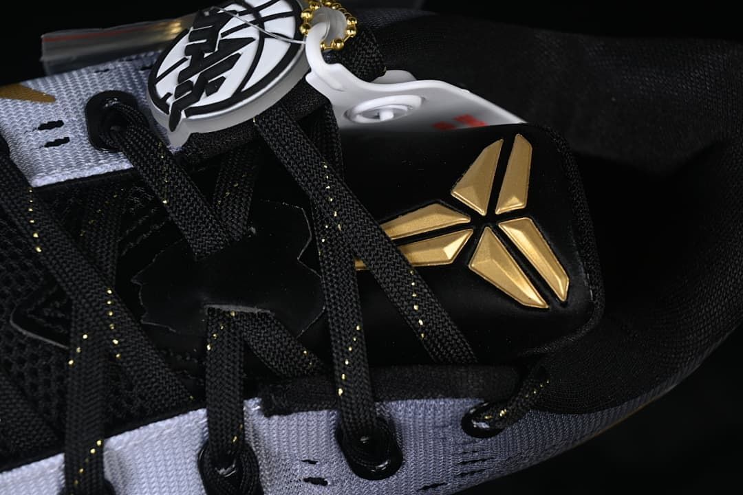 Close-up of black laces and gold Kobe logo on the tongue