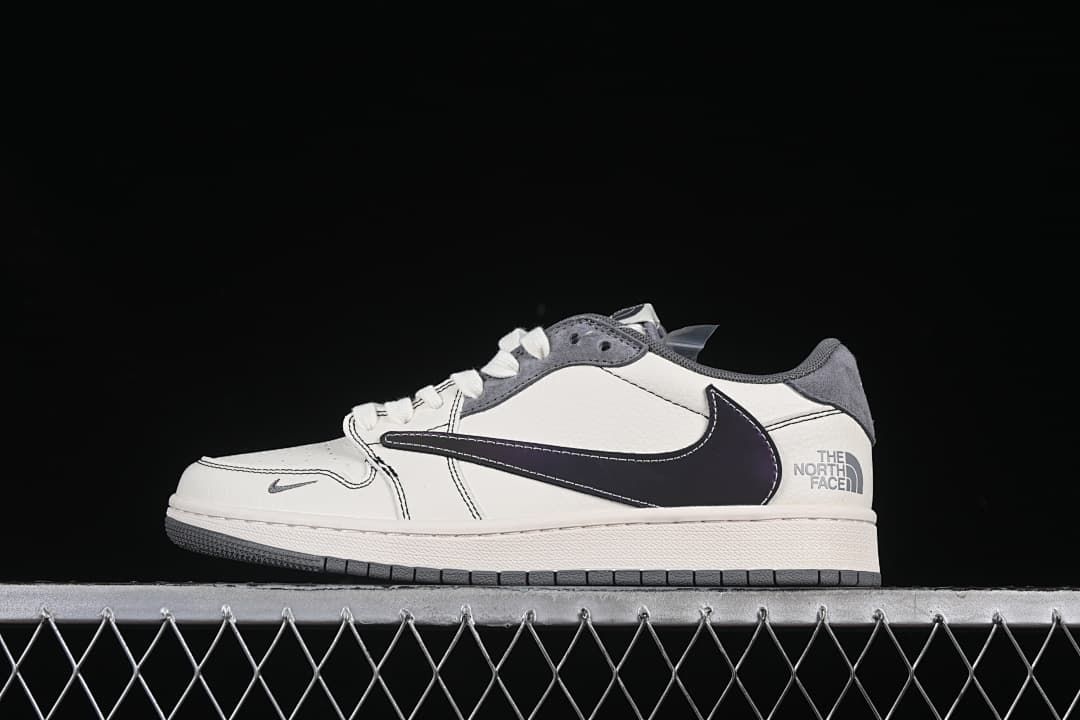 Side view of an off-white low-top sneaker with grey overlays, a dark oversized Swoosh, and heel branding.