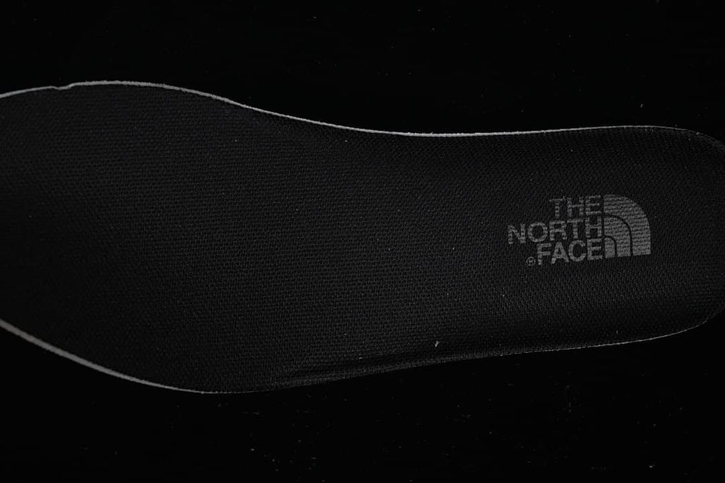 Close-up of a black insole with The North Face logo.