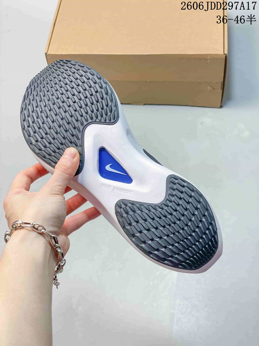 Underside of the Nike Zoom Fly 5 shoe showing a patterned outsole and blue center detail.