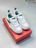 White and green PUMA 180 sneakers displayed on a red shoe box