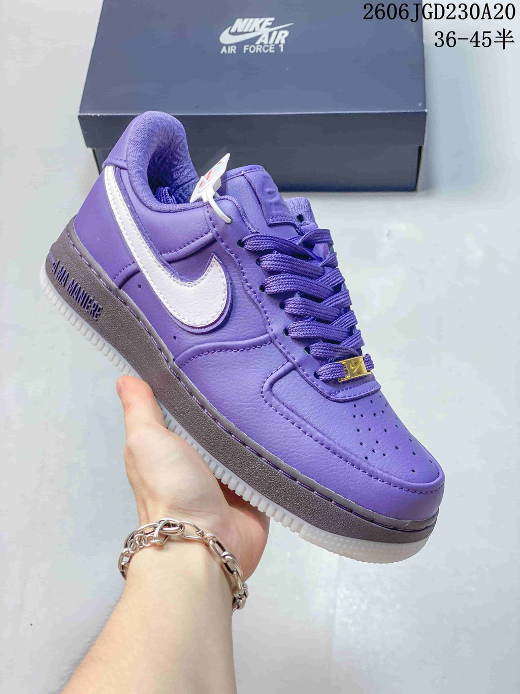 Close-up of a purple low-top sneaker with a white side Swoosh